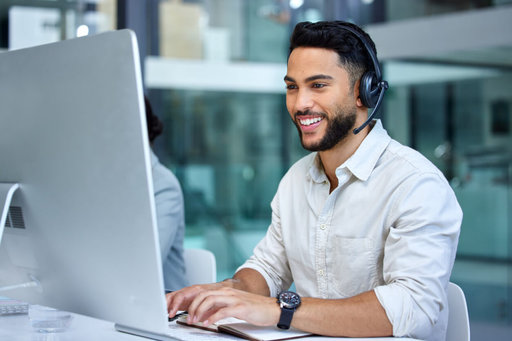 technician smiling and using an Imac